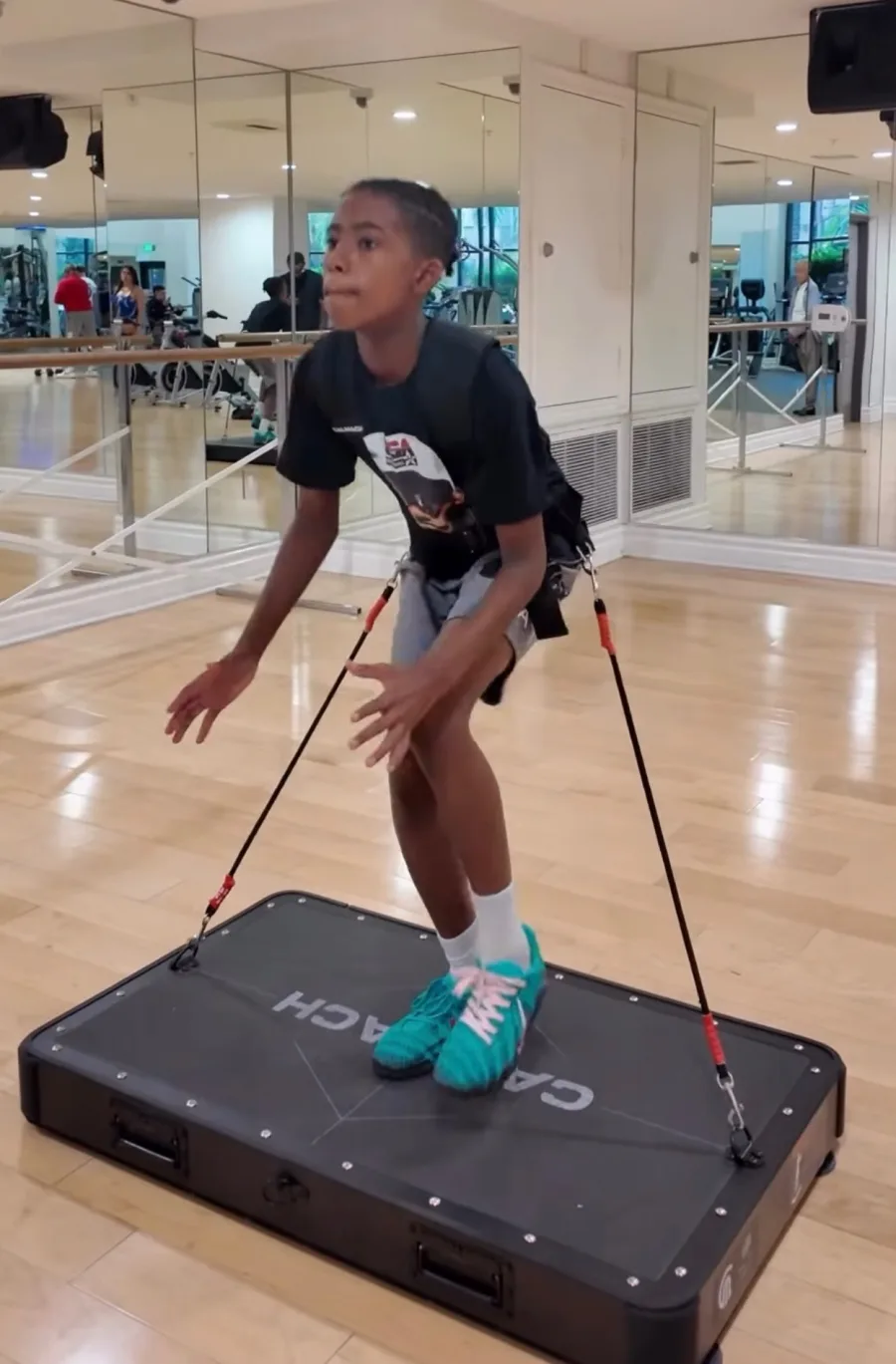 Athlete training on the Calmach platform with resistance bands